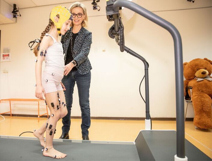 Professor Dominici and a child during experiments at the BabyGaitLab